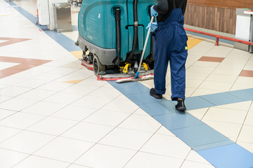 Floor care and cleaning services with washing machine in supermarket. disinfection and sanitization