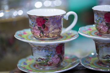 Painted rose on ceramic tea cups 