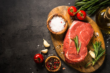 Fresh beef steak on black table.