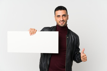 Young man over isolated white background holding an empty white placard for insert a concept