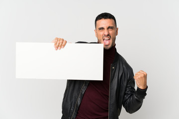 Young man over isolated white background holding an empty white placard for insert a concept