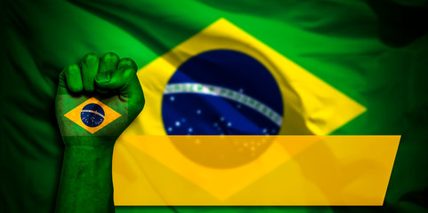 Banner of Flag of Brazil painted on male fist, fist flag, country of Brazil, strength, power, concept of conflict. On a blurred background.