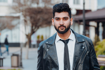 Bearded Indian man walks down the street.