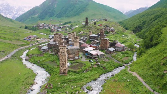 Ancient stone towers and Ushguli village at the foot of Mt. Shkhara. Picturesque and gorgeous scene. Rock tower towers and old houses in Ushguli.