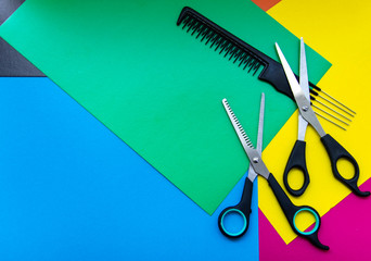 Hair cutting scissors. Thinning scissors. Top view of scissors isolated on a colored background.