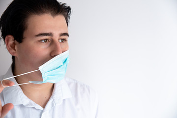 Man putting on medical mask to protect from coronavirus.