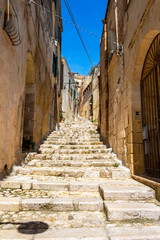 Fototapeta premium Narrow stairway street in the old town of Matera, Province of Matera, Basilicata Region, Italy