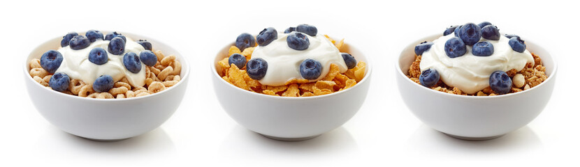 Three bowls of cereals with yogurt and blueberries isolated on white