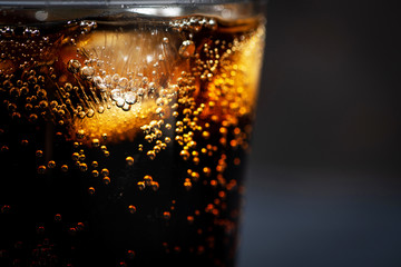 glass of coca cola with ice on a black background