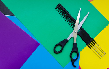 Hair cutting scissors. Thinning scissors. Top view of scissors isolated on a colored background.
