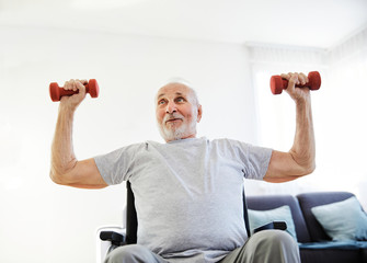 wheelchair senior man exercise physical therapy exercising retirement home elderly man dumbbell...