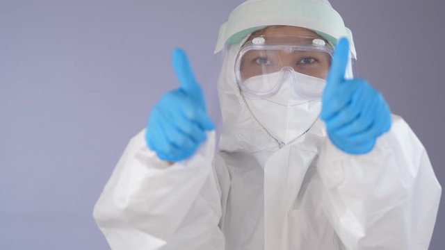 Healthcare Worker in Full PPE Suit Giving Thumbs Up Gesture