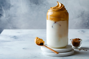 Dalgona coffee. Iced fluffy creamy whipped trend drink with coffee foam and milk. Trendy drink during Covid-19 city lock down and self quarantine, stay at home concept.