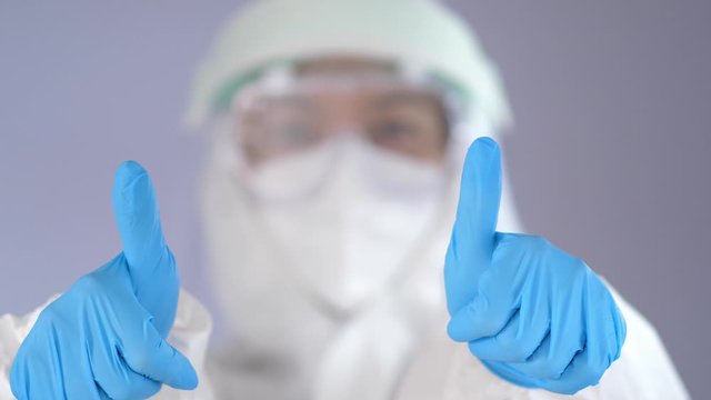 Healthcare Worker in Full PPE Suit Giving Thumbs Up Gesture