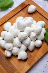 Italian food, fresh fresh green basil and white mini mozzarella soft balls cheese