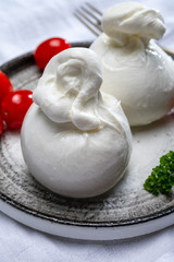 Cheese collection, fresh soft white burrata cheese ball made from mozzarella and cream from Apulia, Italy