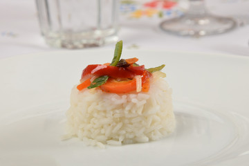 white rice with vegetables on a white plate as a side dish