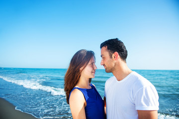 Fototapeta na wymiar Young happy couple on seashore