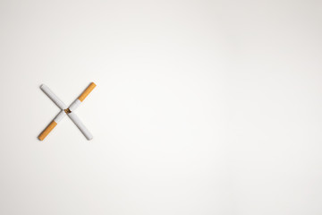 Cigars on white background making an x to quit smoking