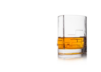 Scotch whiskey in crystal modern glass on white background.