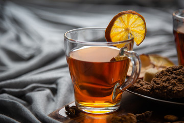 Hot spicy tea in bed with chocolate cookies cinnamon lemon and sugar