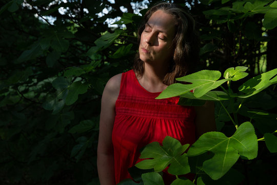 Woman in red slip by fig tree 2