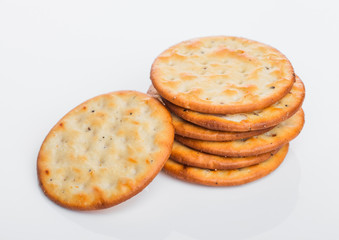 Stack of round organic crispy salty crackers on white.Top view