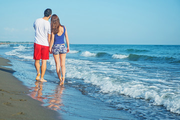 Young happy couple on seashore 