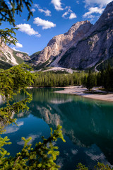 Fototapeta na wymiar Lake of Braies in the Fanes-Sennes-Prags natural park. Mountain lake in the dolomites of South Tyrol or Sudtirol. A beautiful sunny day, a relaxing landscape with bright colors. Italy.