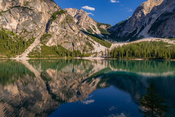 Fototapeta na wymiar Braies Lake or Pragser Wildsee in the Fanes-Sennes-Prags natural park. Mountain lake in the dolomites of South Tyrol or Sudtirol. A beautiful sunny day, a relaxing landscape with bright colors. Italy.