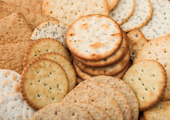 Various organic crispy wheat, rye and corn flatbread crackers with sesame and salt. Top view