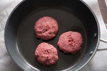 Homemade veggie patties on skillet