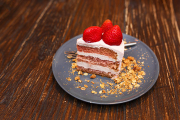 Sweet cakes with summer berries on a wooden table. Party, sweet table. Summer offer desserts in the restaurant.
