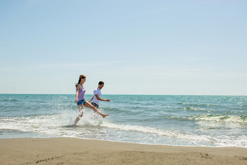 Fototapeta na wymiar Young happy couple on seashore