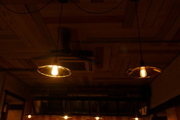 Stylish lighting lamps over a bar counter in a loft hookah bar