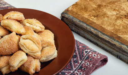 Crispy cottage cheese cookies lies on a brown plate