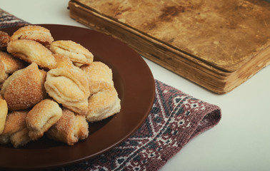Crispy cottage cheese cookies lies on a brown plate