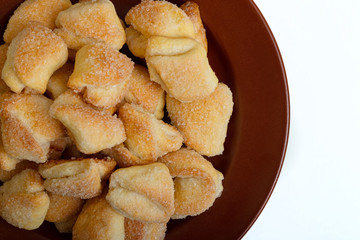 Crispy cottage cheese cookies lies on a brown plate