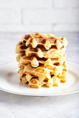 delicious homemade waffles served in white plate on a white table