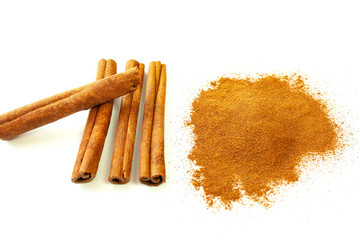  Cinnamon sticks and ground cinnamon on a white background