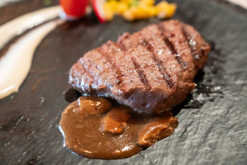 Delicious medium rare wagyu beef  steak with gravy sauce.