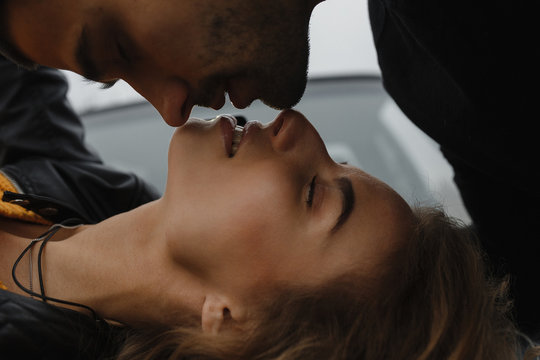 Closeup portrait of the man kissing his lying woman