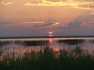 sunset over the river. Mysterious sunset over the lake. Summer evening at sunset.