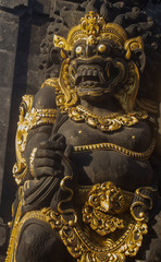 Black and gold guardian of the gate, Balinese statue - obrazy, fototapety, plakaty