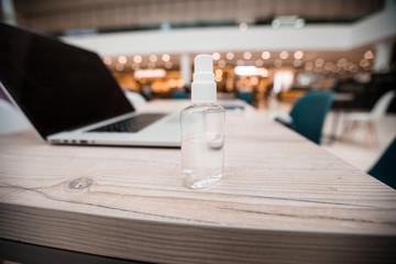 laptop and germicidal spray on the office Desk