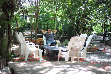 A man resting on a chair in the garden