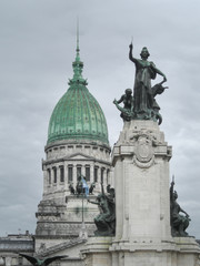Fototapeta na wymiar Statue and dome building, grey sky 
