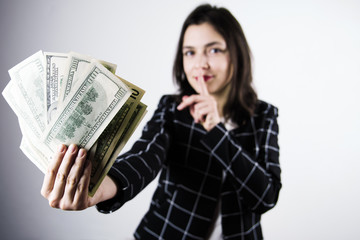 cute successful women holding a pack of money, focus on dollars