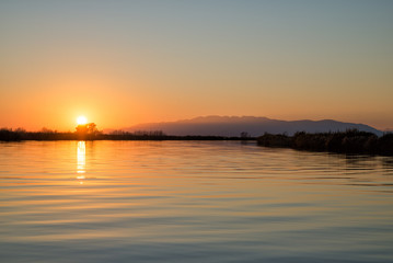 Sunset over river with water reflections