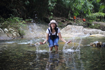 Fototapeta premium Women playing in fun at Khlong Phaibun Waterfall, Chanthaburi, Thailand